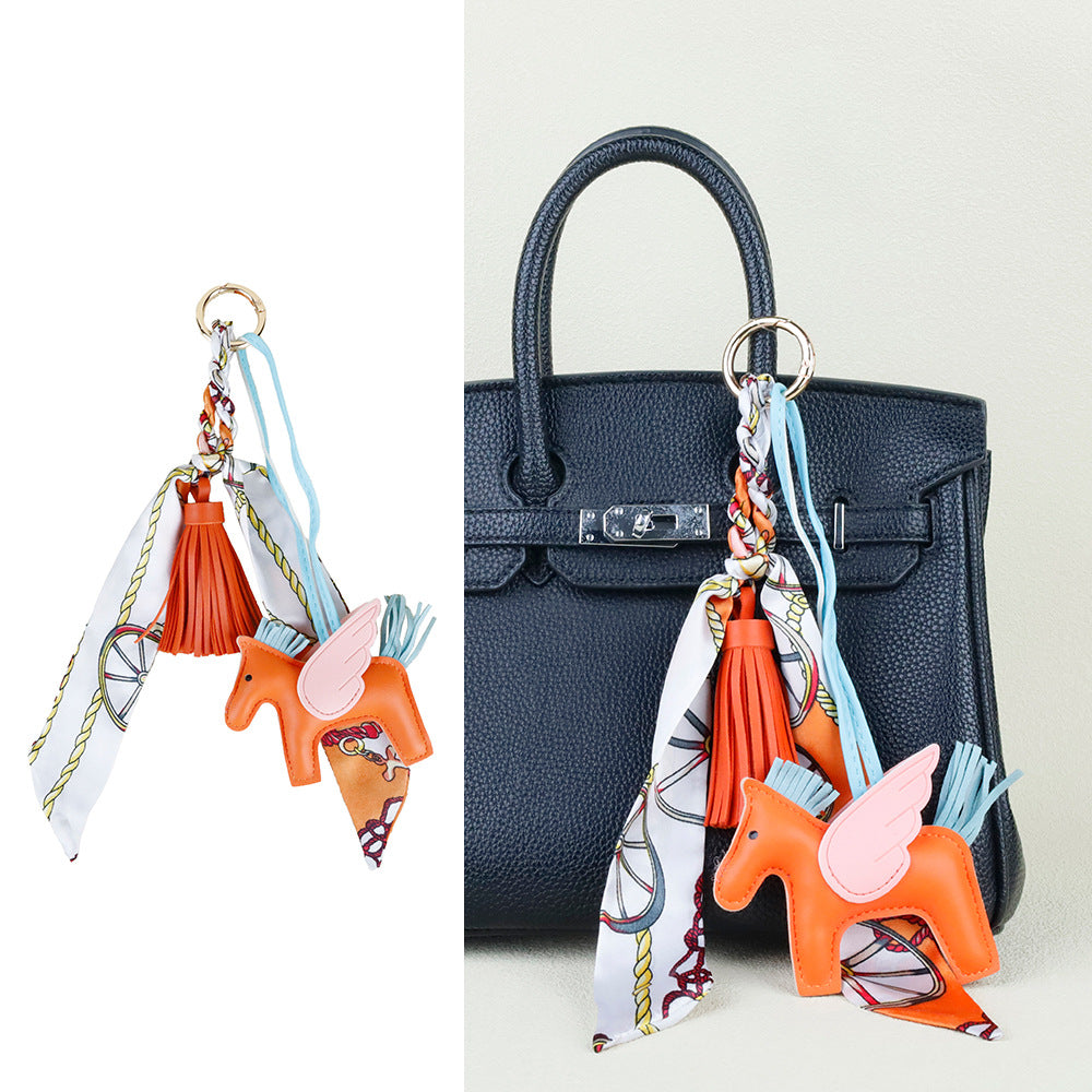 Aesthetic bag ornament featuring a horse motif with fluid tassel accents