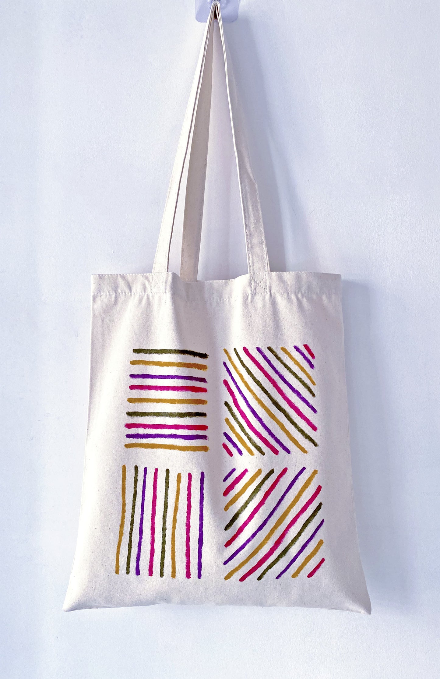 Slouchy canvas bag placed on a park grass during a lazy afternoon.