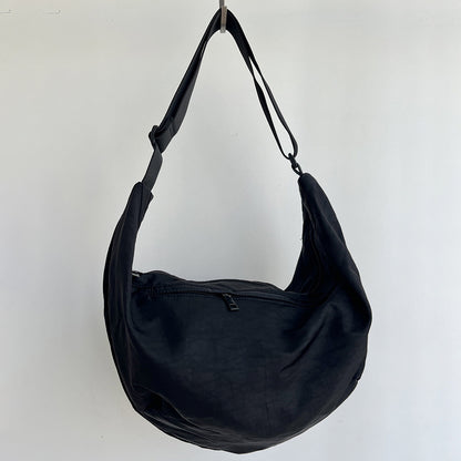 Multi way wear canvas sling bag worn across chest or shoulder