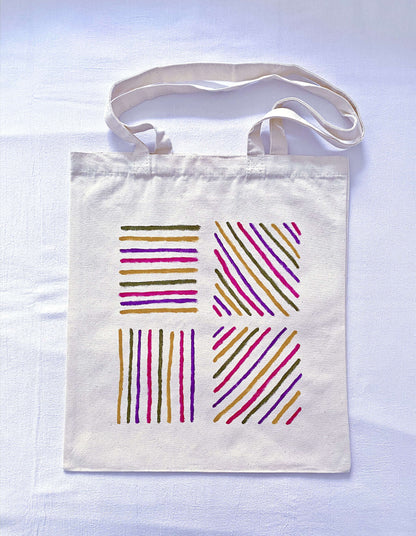 A side view of a roomy canvas tote showing its wide gusset capacity.