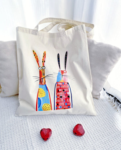 A thoughtful gift for nature lovers featuring a twin bunny print on a soft sustainable fabric background.