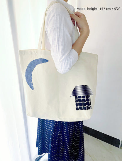 Large fabric bag shown holding books, groceries, and personal items