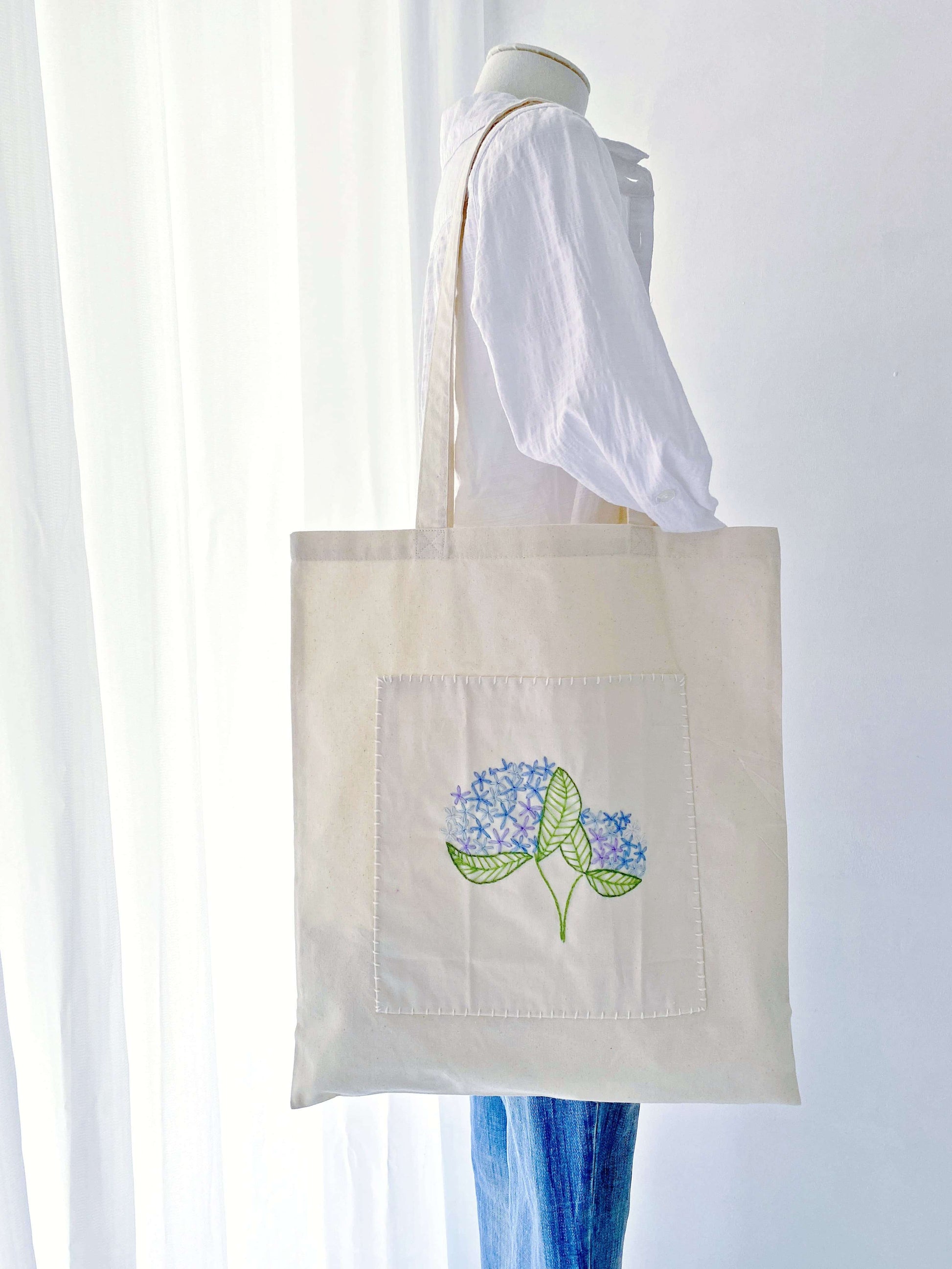 A sentimental gift for mom featuring delicate hand-stitched blooms on a super soft sustainable bag she will cherish daily.