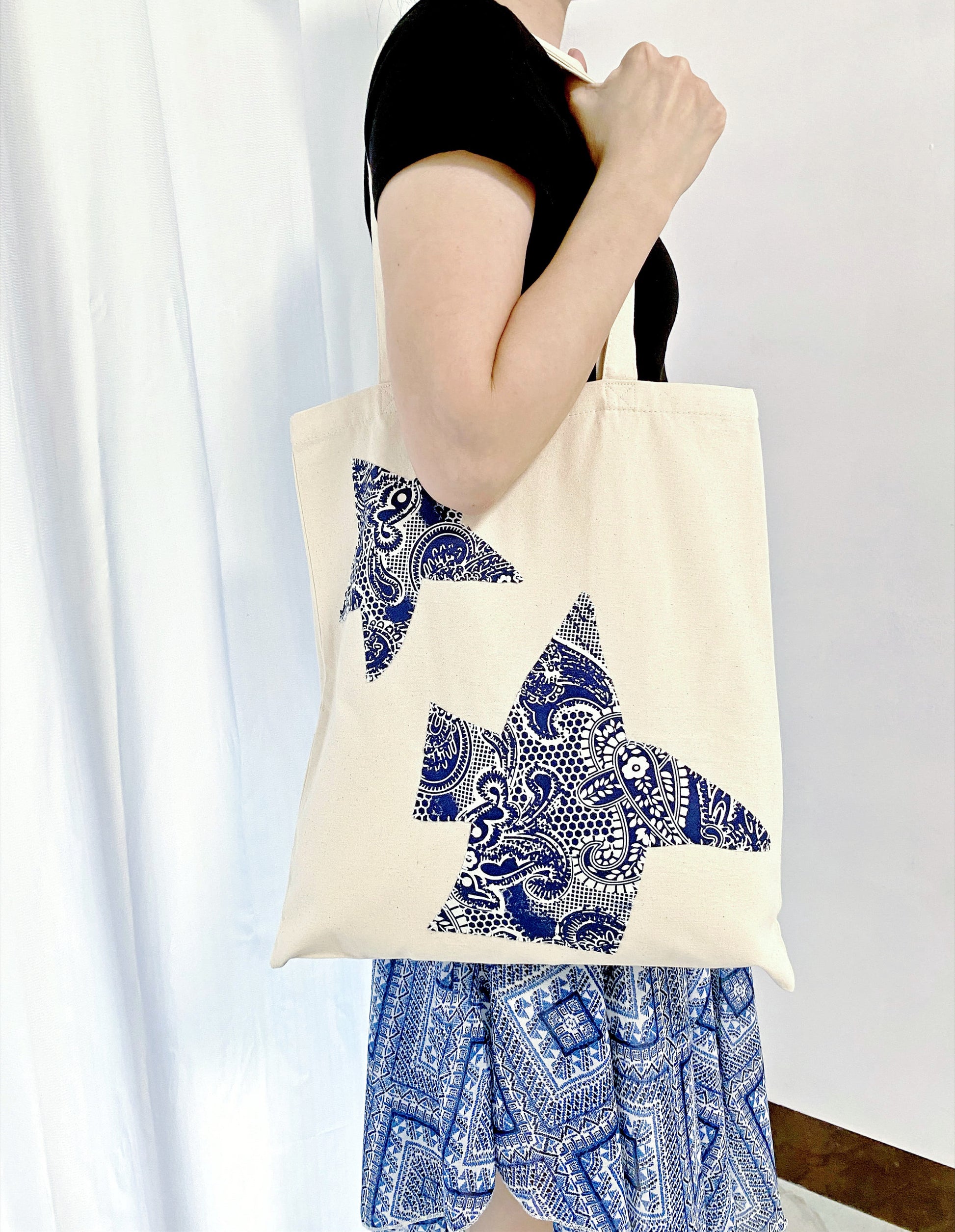Bohemian-inspired canvas tote resting on a cafe chair, representing slow living.