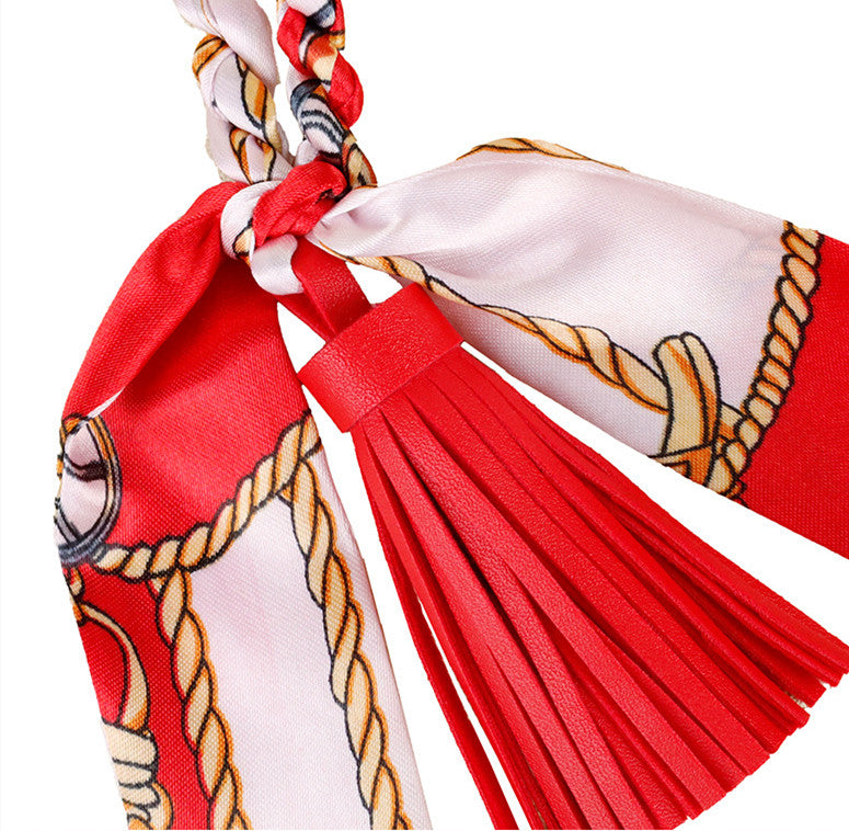 Premium brown leather sausage dog bag charm with silk tassel accents
