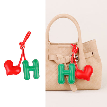 Small alphabet pendant attached to a handbag