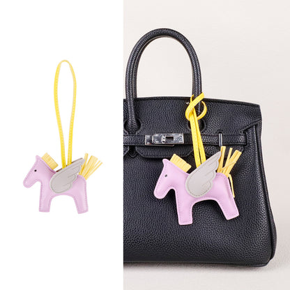 Premium bag accessory clip showing horse silhouette and detailed tassel embellishments
