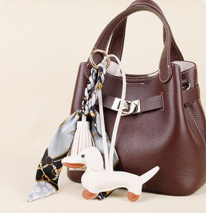 Cute sausage dog purse accessory with vibrant silk tassel detailing