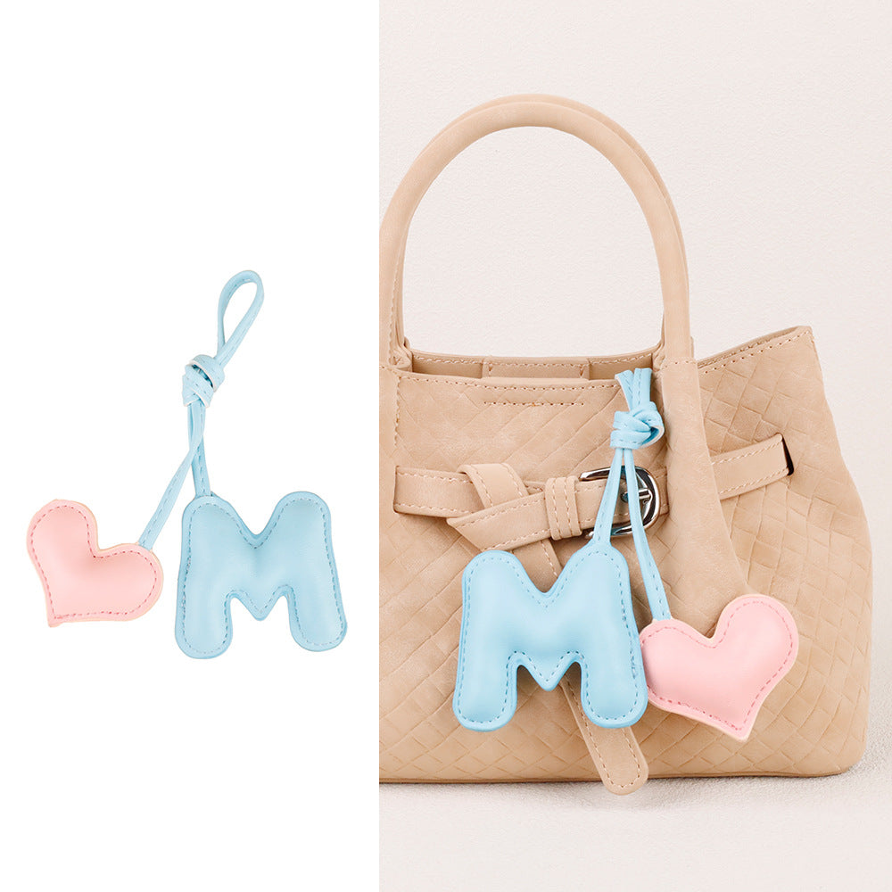 Padded leather charm shown against a neutral background