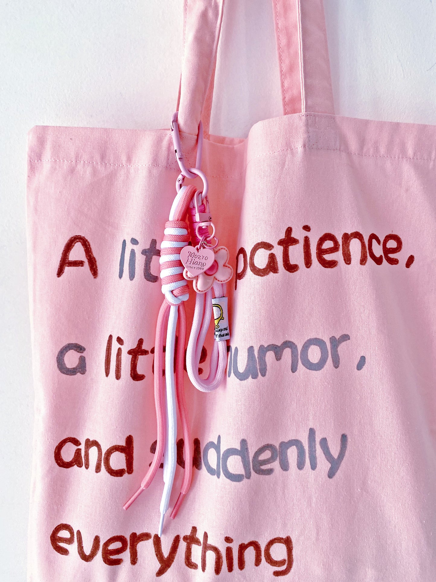 soft tote bag holding a book and a half full water bottle