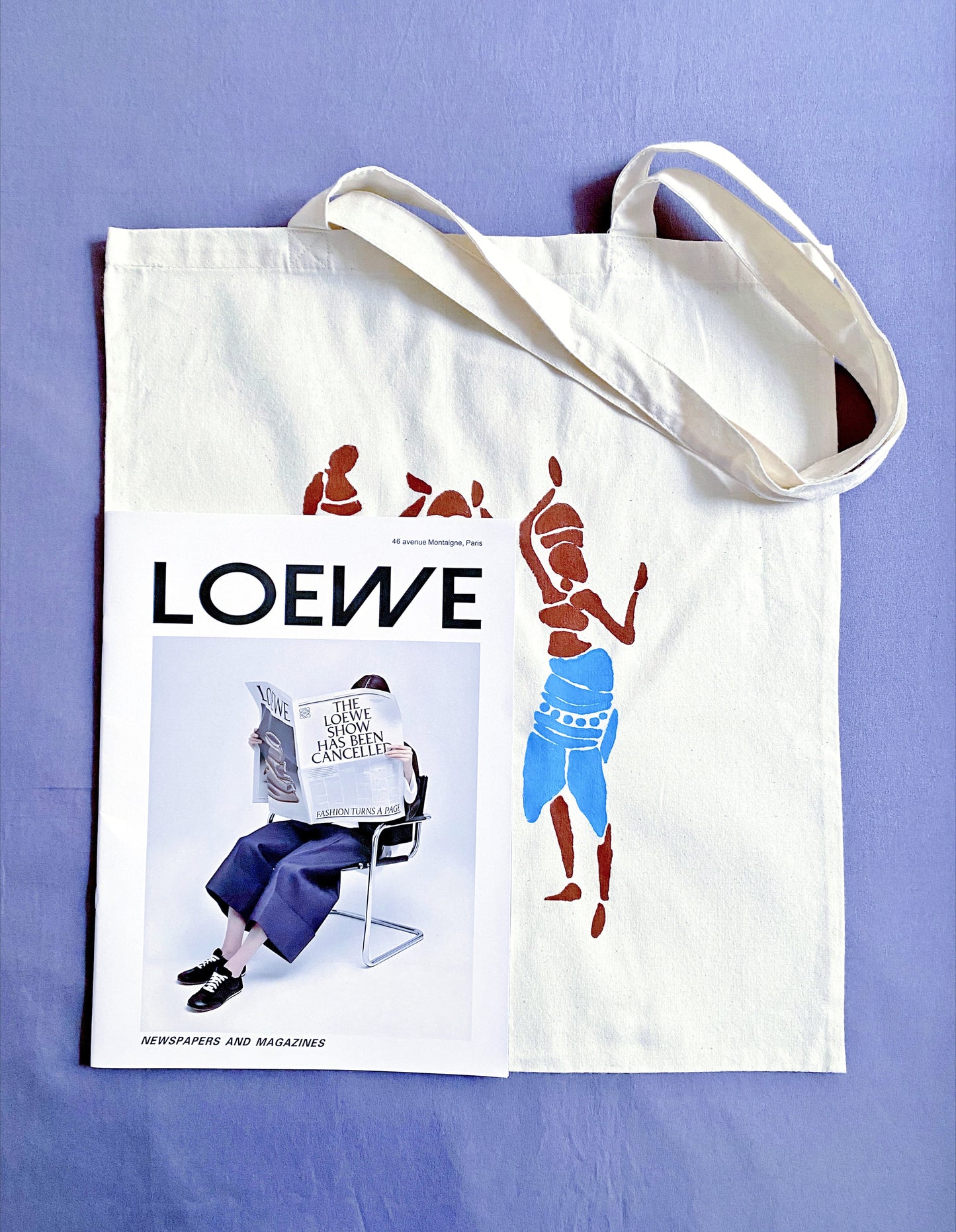 Oversized tote draped over a shoulder, turning a simple jeans-and-tee outfit into a statement of effortless artistic style.