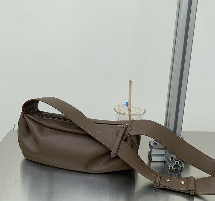 Soft hobo style crossbody purse with reinforced strap stitching for heavy loads