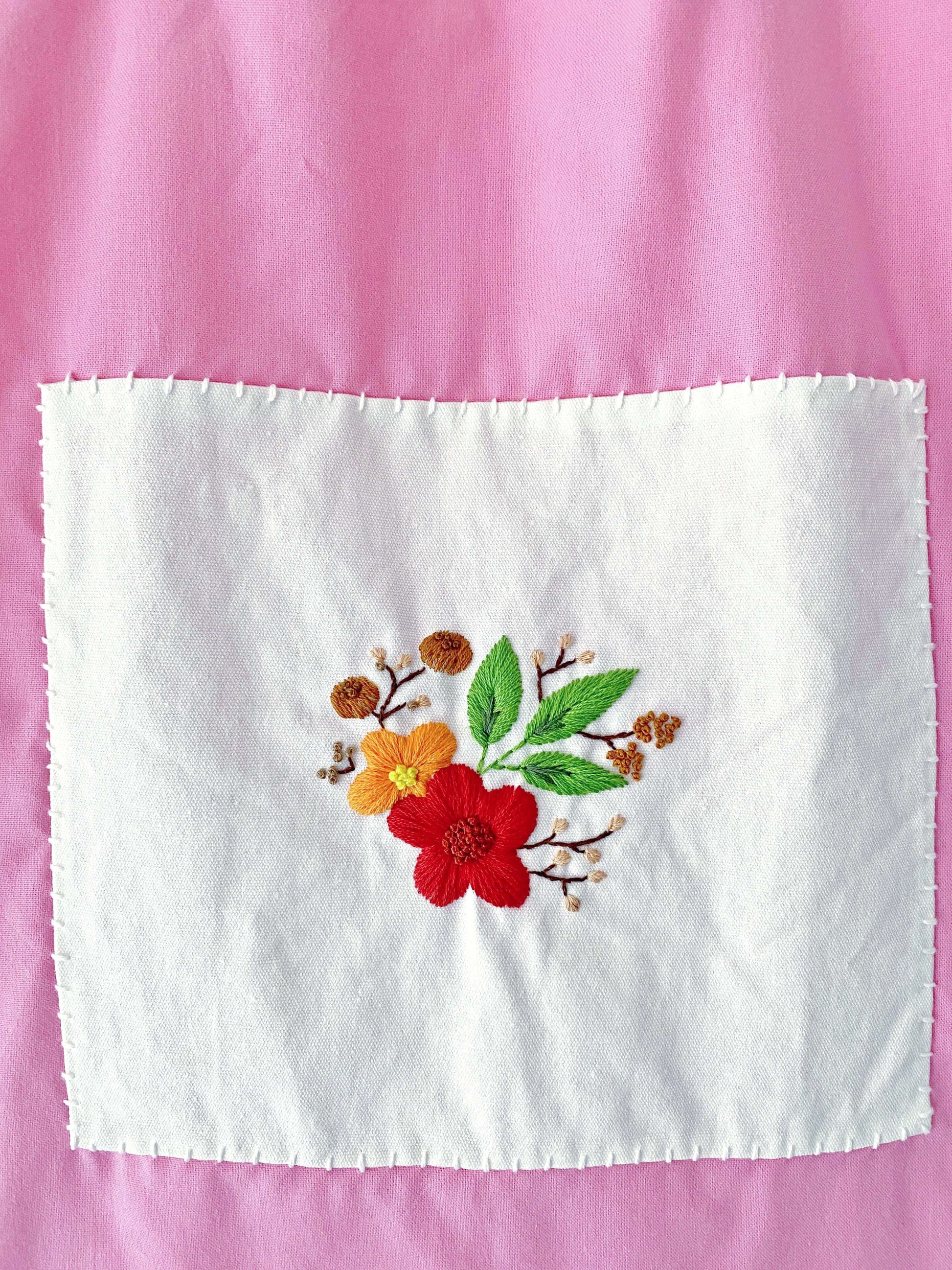 A chic, eco-friendly tote bag made from organic cotton with floral embroidery, perfect for those who want a functional yet stylish accessory, ideal for gifting to loved ones.