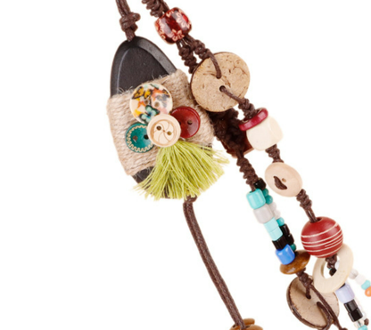 Natural wooden bead accessory clipped to a handbag