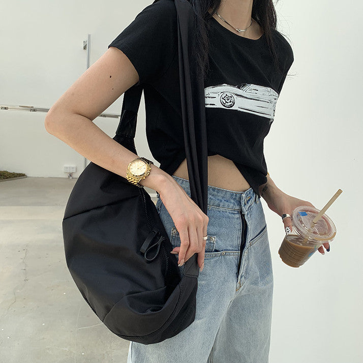 Curved crossbody purse with a compact shape for city strolls