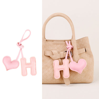 Handmade heart accessory styled on a daily handbag