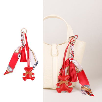 Trendy handbag accent piece featuring a detailed bear purse charm ornament