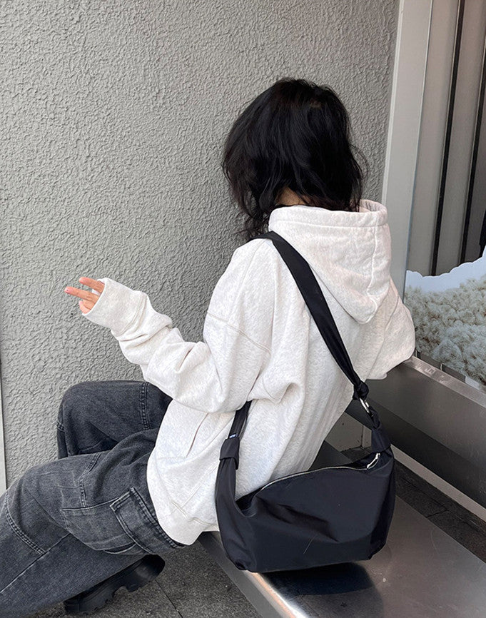 Water-resistant shoulder bag for outdoor walks
