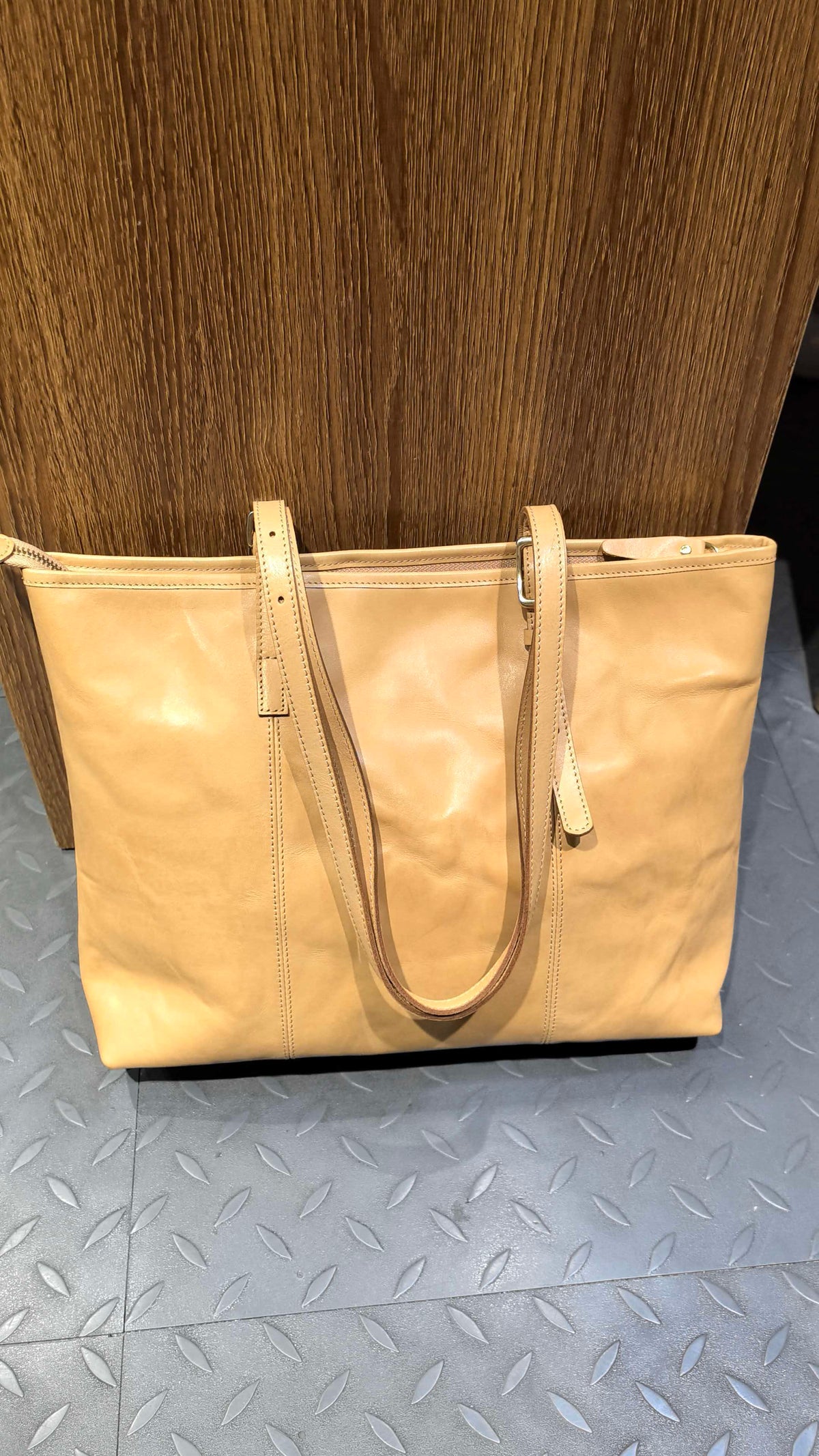 Tall business-style handbag with practical storage for office supplies and travel items.