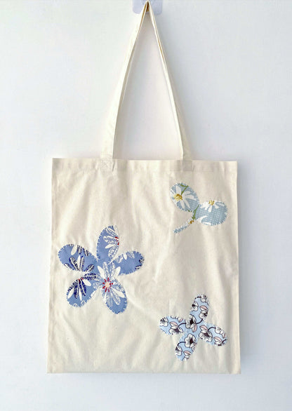 Soft cotton tote with hand-stitched patchwork detail, often chosen as a meaningful gift for friends who appreciate sustainable living and quiet design