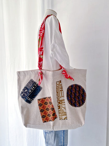 Neutral patchwork tote bag styled as a simple present for a travel loving friend