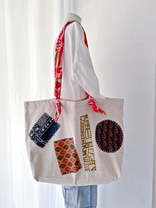 Neutral patchwork tote bag styled as a simple present for a travel loving friend