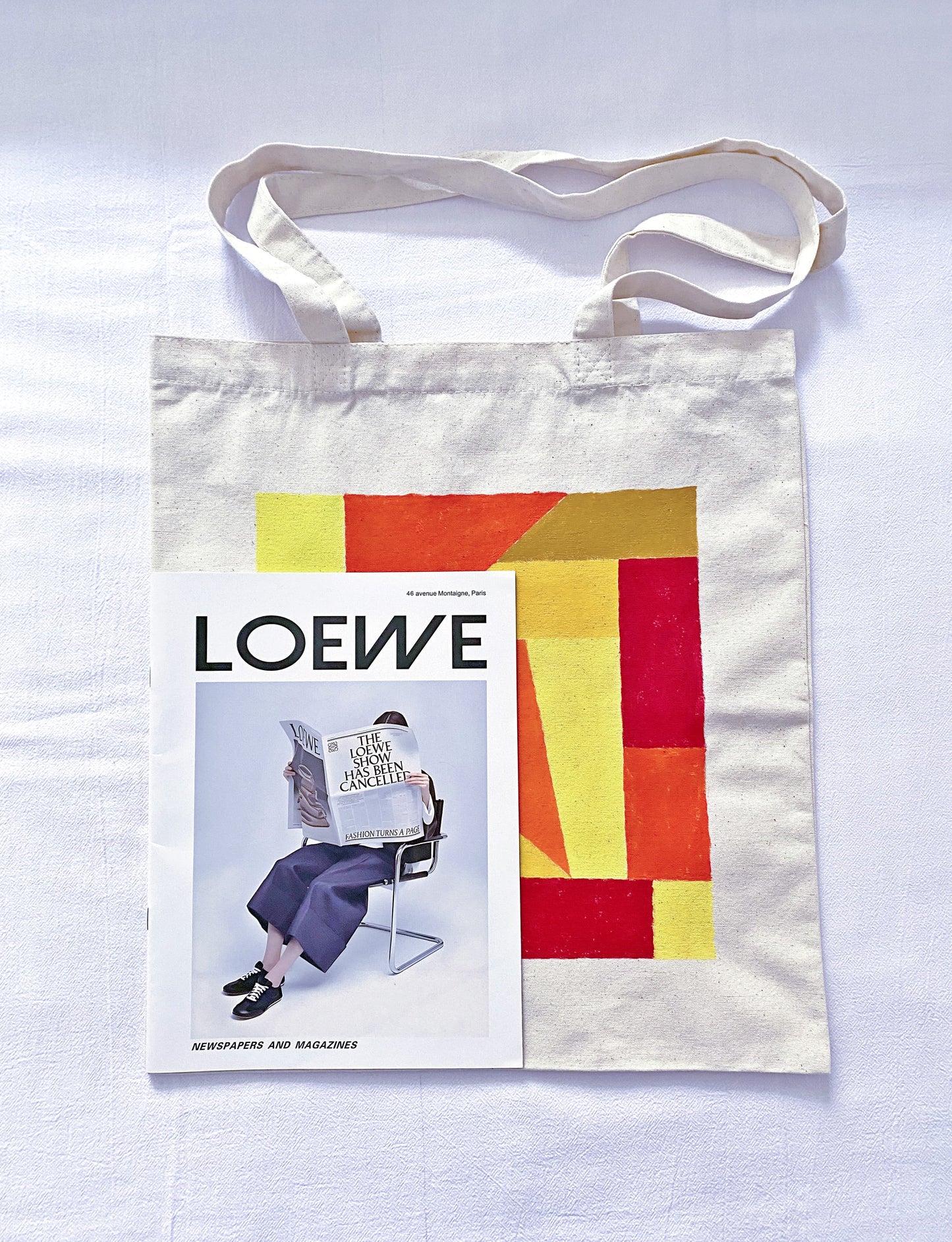 The natural drape of a soft canvas bag worn over a thick winter sweater.