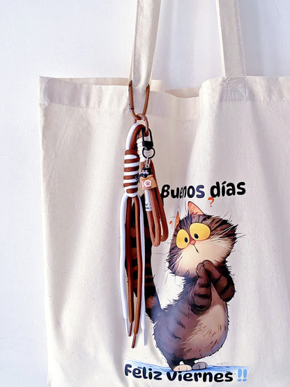 A whimsical minimalist kitty illustration on a sustainable cream fabric bag.