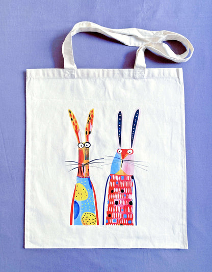 Close-up of ultra-soft natural cotton fabric texture featuring a hand-printed bunny design, showing the breathable weave that feels gentle against the skin.