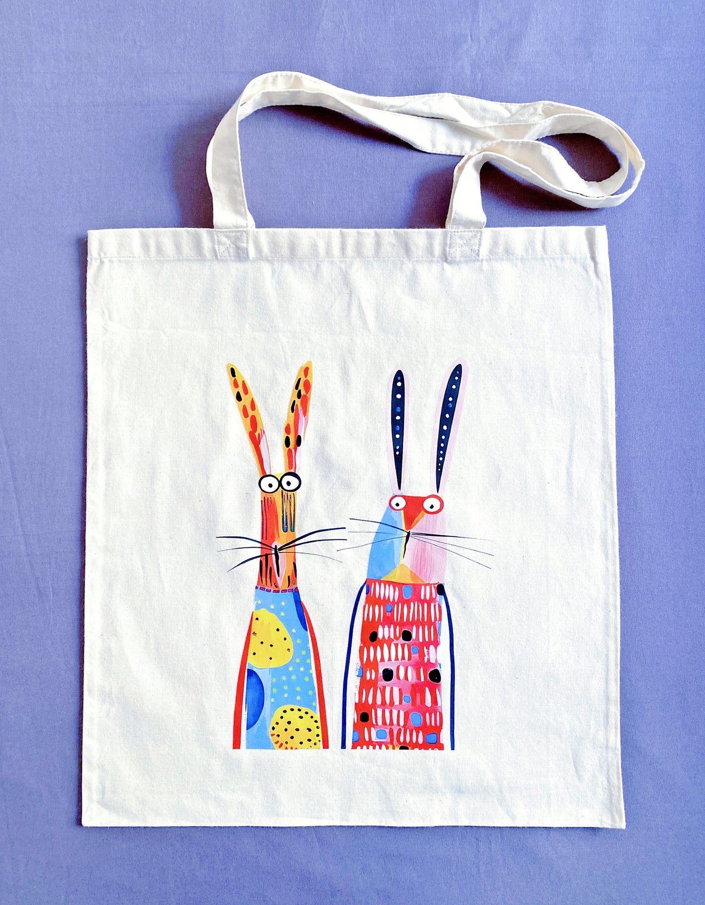 Close-up of ultra-soft natural cotton fabric texture featuring a hand-printed bunny design, showing the breathable weave that feels gentle against the skin.