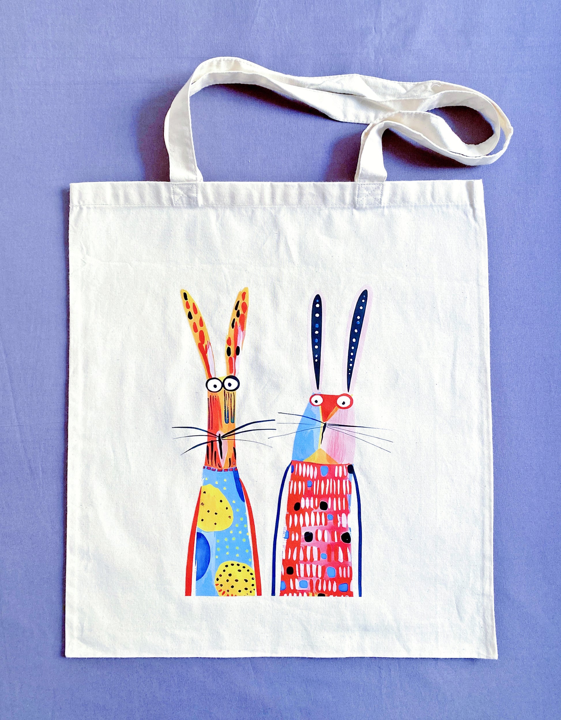 Close-up of ultra-soft natural cotton fabric texture featuring a hand-printed bunny design, showing the breathable weave that feels gentle against the skin.