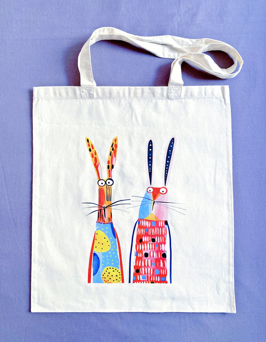 Close-up of ultra-soft natural cotton fabric texture featuring a hand-printed bunny design, showing the breathable weave that feels gentle against the skin.