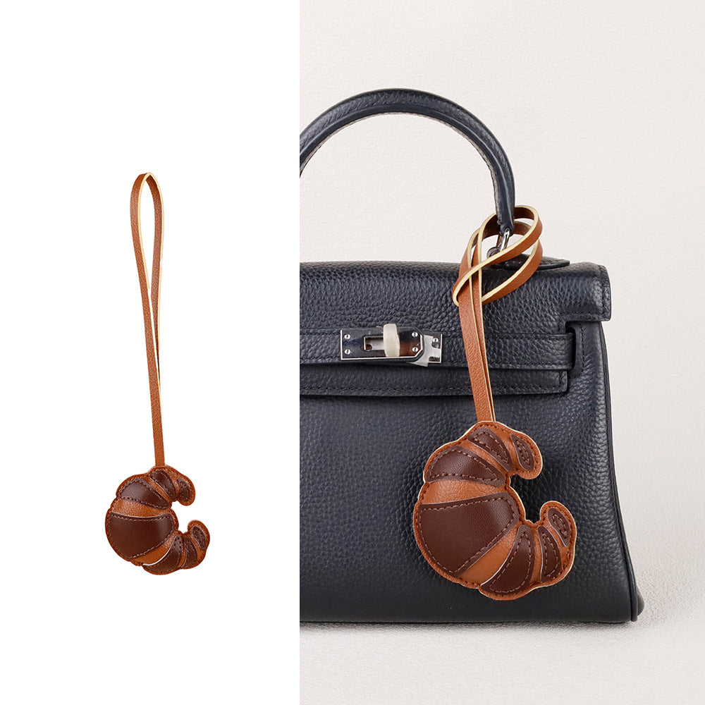 Handmade accessory gift displayed beside a stylish handbag