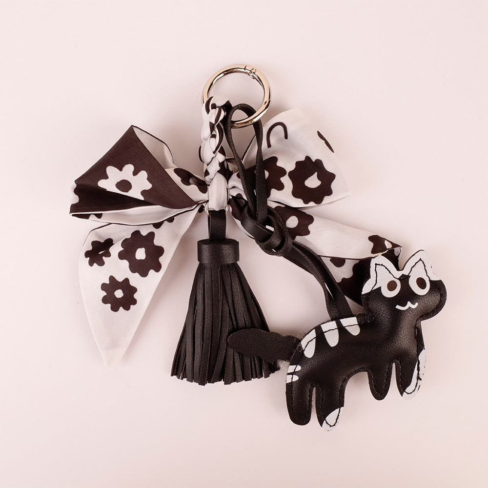 Handcrafted black silk bow keychain packaged as a cute birthday present