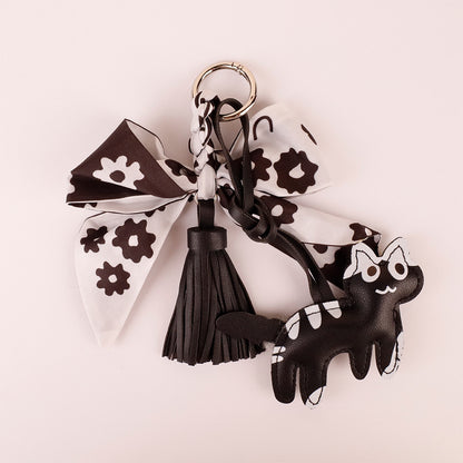 Handcrafted black silk bow keychain packaged as a cute birthday present