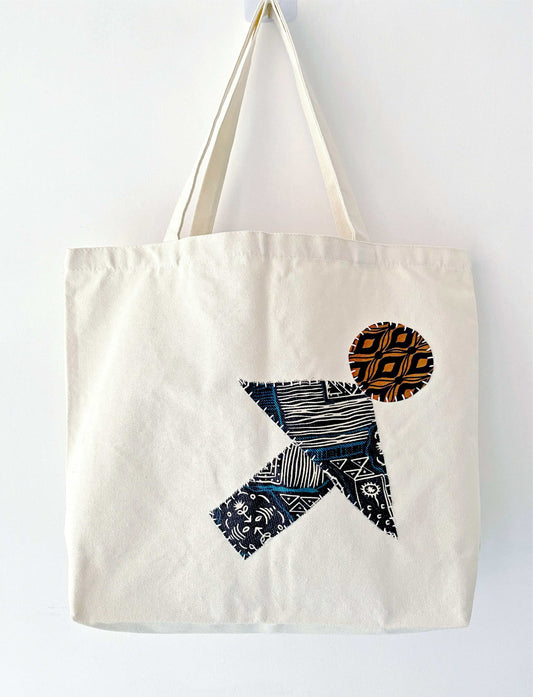 Large natural canvas tote filled with fresh baguettes and flowers, showing the durable weight capacity for weekly zero-waste market runs without losing shape.