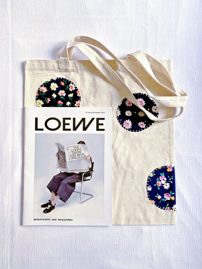 Sustainable canvas tote bag with a relaxed silhouette and decorative patchwork, suitable as a thoughtful everyday gift