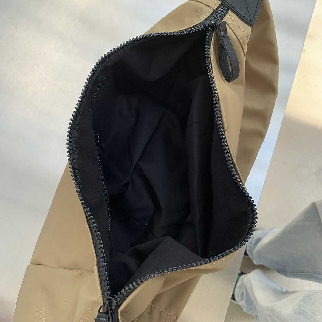 Crescent crossbody bag worn with a relaxed casual outfit