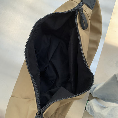 Crescent crossbody bag worn with a relaxed casual outfit