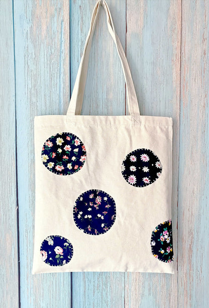 Artistic flat-lay of the foldable cotton bag next to a vintage camera and a notebook, embodying a traveler’s aesthetic.