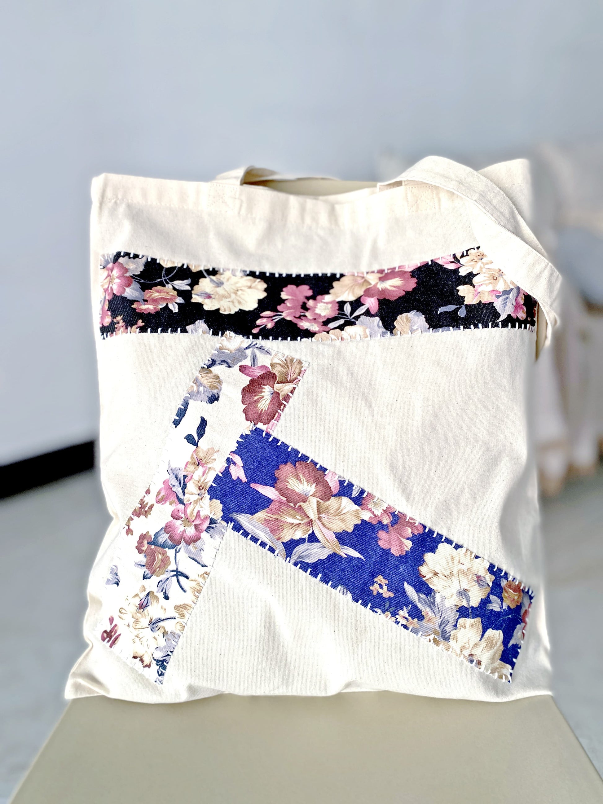 Soft-touch cotton bag with an artisan patchwork pattern for personalized style.