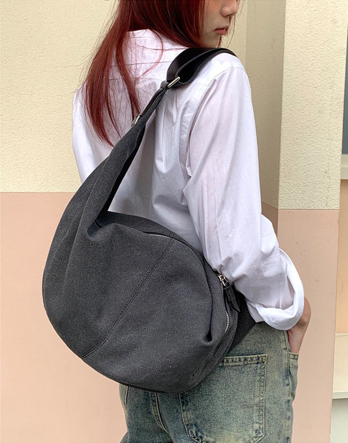 Women's canvas crescent bag styled for a casual city outing