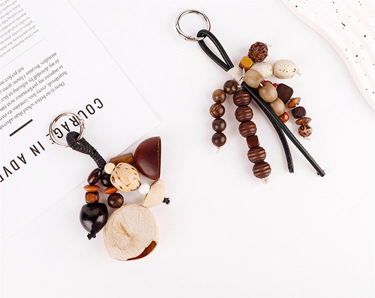 Natural seed bead charm displayed beside a cotton tote