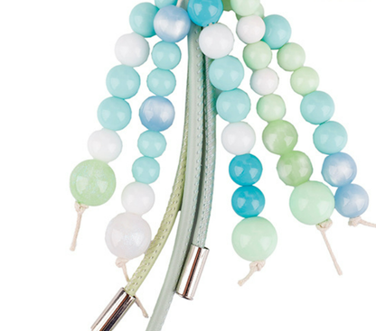 Green stone keychain accessory with long soft tassels