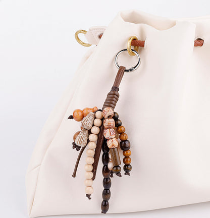 Natural wood bead accessory for a daily carry bag