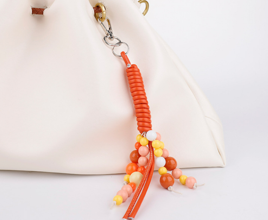 Small beaded ornament attached near a tote handle