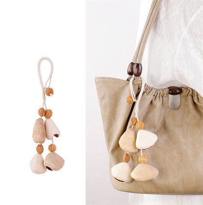 Small rattle ornament attached to a tote handle