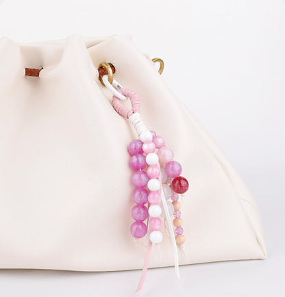 Pink jade accessory adding detail to an everyday handbag