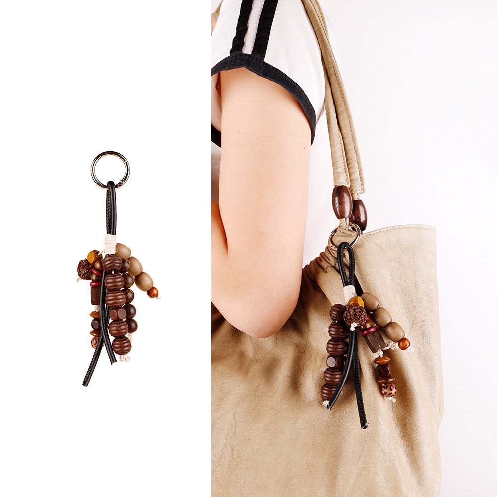 Fruit shell pendant with seed beads and wooden accents