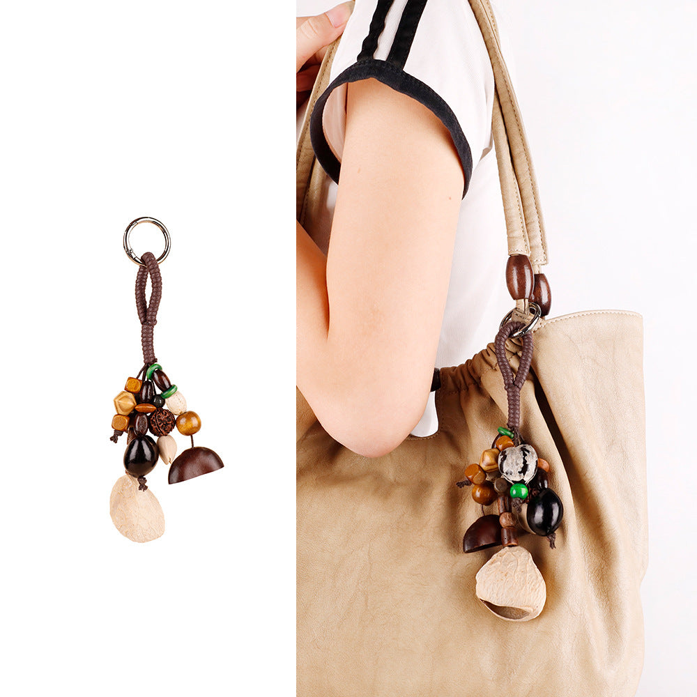 Natural wood and shell beads arranged as a hanging keychain